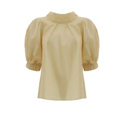 Blouse Add a touch of vintage charm to your collection with this short-sleeve puff blouse, made from a delicate cotton blend. The blouse features a flattering high neckline and voluminous puff sleeves, creating a romantic and feminine silhouette.  Perfect for both casual and formal occasions, this blouse pairs beautifully with high-waisted skirts or tailored trousers. The lightweight fabric ensures comfort, making it an ideal choice for warmer days. Equipped with a zipper. Made in Moldova Artisa Puff Blouse, Waisted Skirts, Shirt Blouses Women's, Feminine Silhouette, Yellow Blouse, Fashion Industry, Tailored Trousers, Independent Designers Fashion, High Neckline