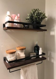 two shelves above the toilet are filled with personal care items, such as soaps and lotions