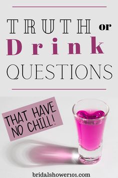 a glass filled with pink liquid next to a sign that says truth or drink questions