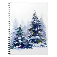 a notebook with watercolor painting of trees in the snow on top of white paper