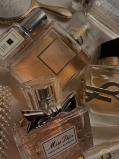 an assortment of perfumes on a table