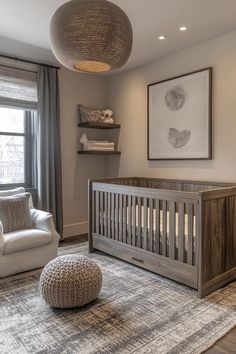 a baby's room with a crib, chair and ottoman