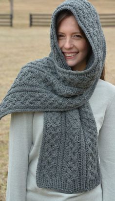 a woman wearing a gray knitted scarf