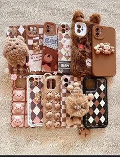 there are many cell phones and teddy bears on the floor with one bear sticking out of it's back