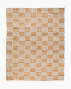 an orange and white checkered rug on a white surface with no one in it