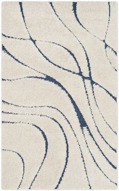 a white and blue rug with wavy lines on the top, in front of a white background