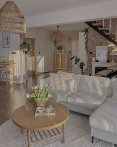 a living room filled with furniture and a staircase