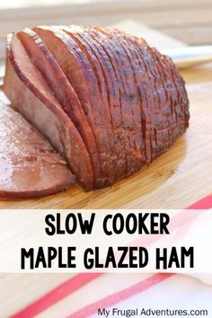 a sliced ham sitting on top of a wooden cutting board