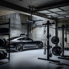 a black sports car is parked in a garage next to other cars and exercise equipment