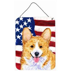 a brown and white dog with an american flag on it's back hanging from a hook