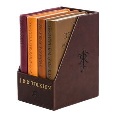 a set of four books in a book holder