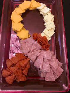 an assortment of meats and cheese on a plate