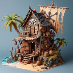 a pirate themed house on top of a rock next to the ocean and palm trees