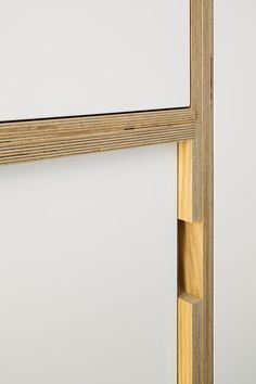 a close up of a wooden frame on a white wall