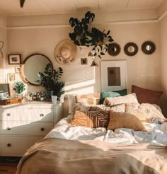 a bed room with a neatly made bed and lots of plants on the headboard