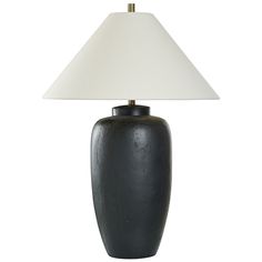 a black table lamp with a white shade on it