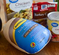 an assortment of frozen food items on a wooden table with eggs, turkey and cranberry sauce