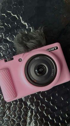 a pink camera sitting on top of a table