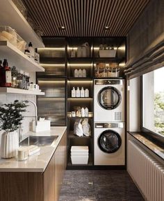 a washer and dryer in a small room next to a window with open shelves