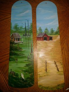 two painted bookmarks depicting farm scenes on wooden boards with green grass and red barns in the background