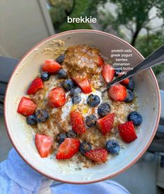 a bowl of oatmeal with berries and blueberries