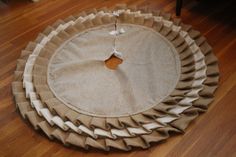 a round rug with ruffled edges on the floor