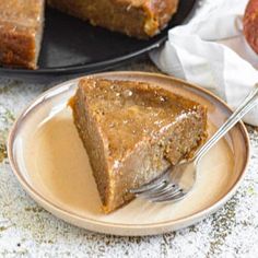 a slice of pumpkin pie on a plate with a fork in front of the cake