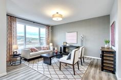 a living room filled with furniture and a large window