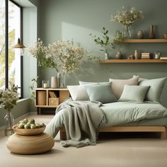 a bedroom with green walls and wooden shelves filled with flowers, plants and other items