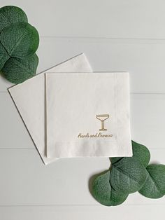 two napkins on top of each other with the words and wine glasses printed on them