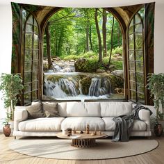 a living room with a large window and waterfall in the woods on it's wall