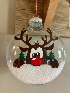 a glass ornament with a reindeer on it