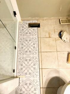 a white toilet sitting next to a bath tub in a bathroom on top of a tiled floor