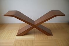 a wooden bench sitting on top of a hard wood floor