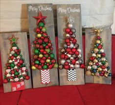 three small christmas trees are on display in front of some bags that have ornaments on them