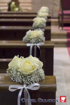 white roses and baby's breath tied to pews