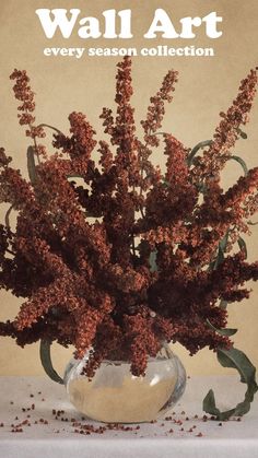 a vase filled with lots of purple flowers on top of a white table covered in dirt