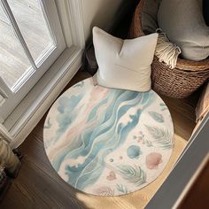 a round rug on the floor next to a basket with pillows and other items in it