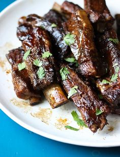 some meat is sitting on a white plate