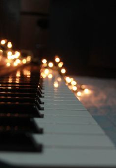 a piano with many lights on it in the dark