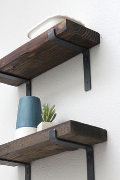 two wooden shelves with pots and plants on them