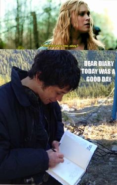 a man writing on top of a book next to a woman with long hair and an open notebook