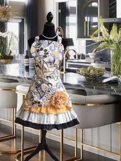 a mannequin with a dress on display in a kitchen