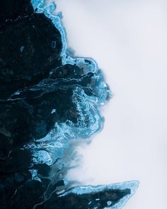 an aerial view of the ocean and land from above, looking down at it's water