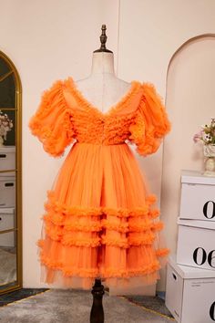 Constructed from tulle and featuring a stylish A-line silhouette, this Orange Short Princess Dress boasts eye-catching ruffles and short sleeves. The V neck and zip-up back offer further styling options, while the length ensures a chic, short-style look. Item #NP1016 Material: Tulle Silhouette: A-line Embellishment: Ruffles, and short sleeves Neck: V neck Back: Zip-up back Length: Short Fully lined: No Built-in bra: Yes True to size. Made in China. Dresses are usually packed inside out for prote Short Princess Dress, Sun Spot, Destination Wedding Ceremony, Short Cake, Formal Ideas, Tulle Material, The Kraken, Dress With Puff Sleeves, Elegant Prom