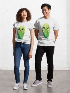 two people standing next to each other wearing t - shirts with the same image on them