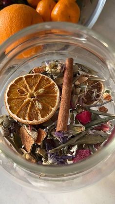 orange slices, herbs and spices in a glass bowl