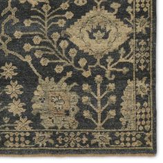 an antique rug with floral design on the front and side, in dark blue tones