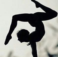 a man doing a handstand on top of a skateboard in the air