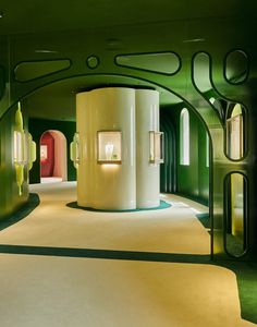 the interior of an art deco building with green and white walls, arched doorways and circular windows